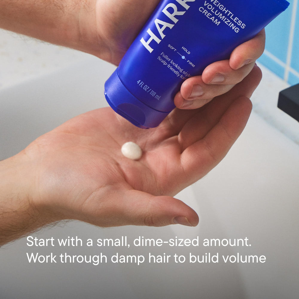 Hand applying Harry's cream to damp hair for easy distribution benefit