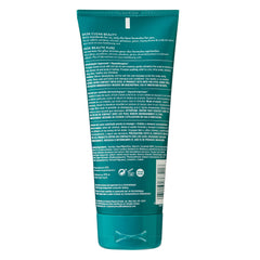 HASK pre-shampoo scrub in hand applied to wet scalp demonstrating easy massage application