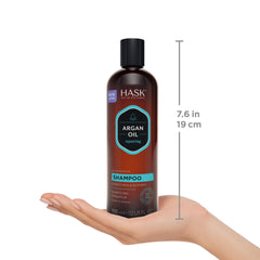 HASK 12 fl oz bottle in hand showing true product scale
