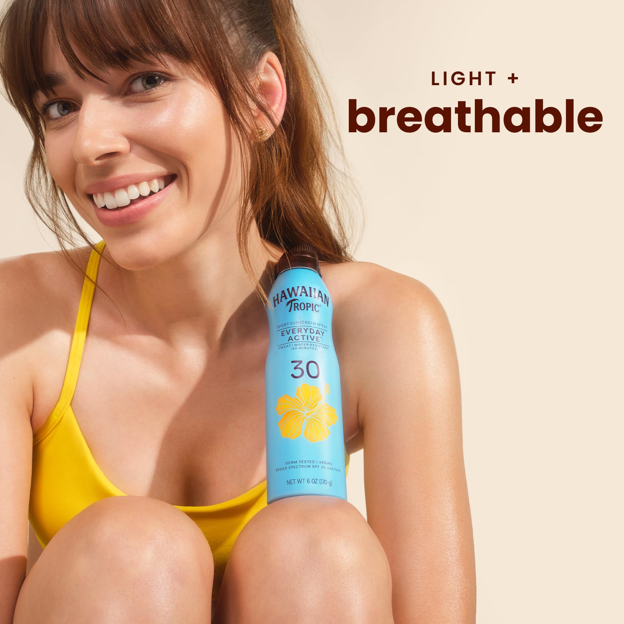 Hawaiian Tropic clear spray mist on skin demonstrating non-greasy finish