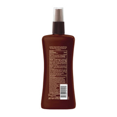 Hawaiian Tropic bottle on beach towel showing tropical scent and outdoor protection benefit