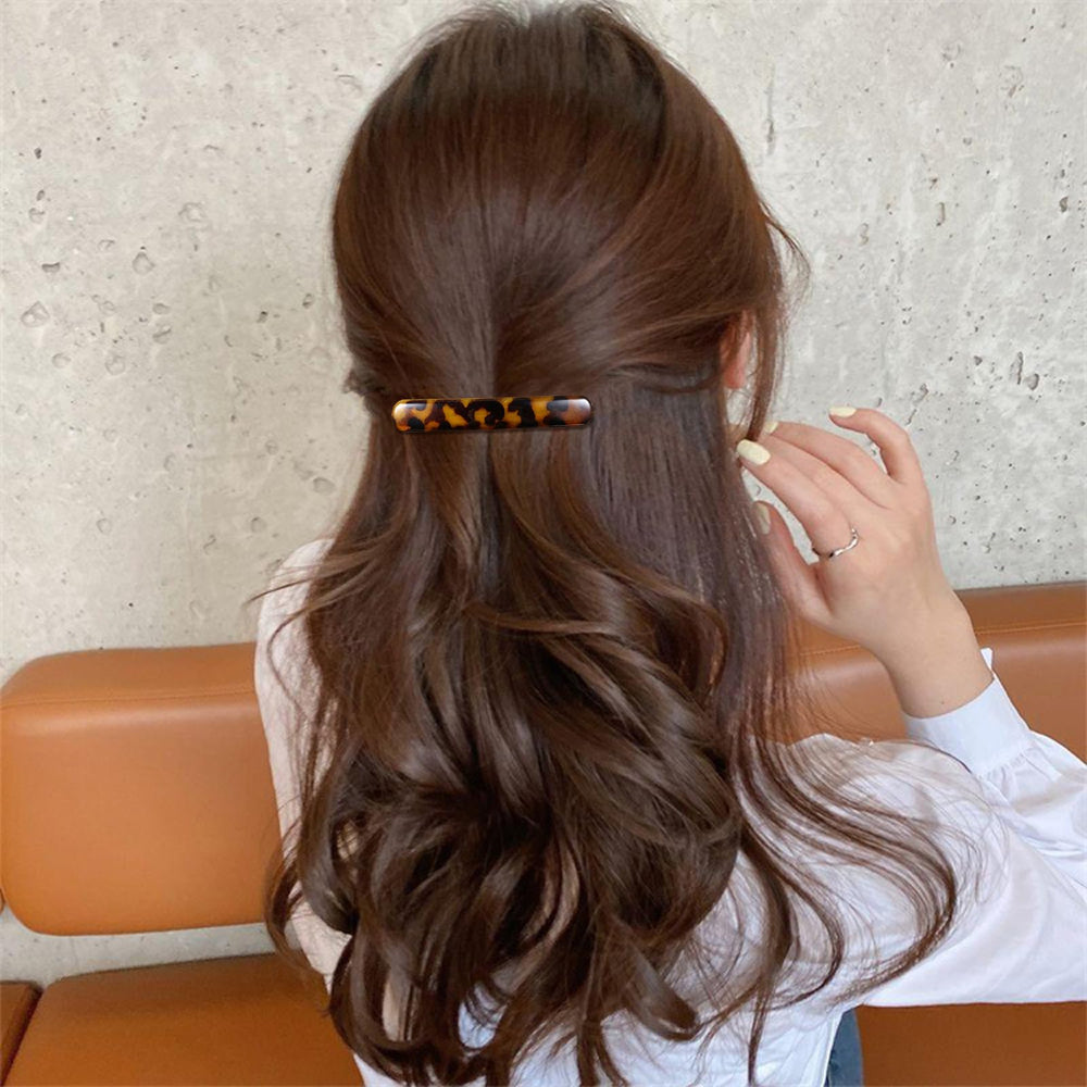 Heclia clip beside ruler showing 2.56-inch size for precise styling control
