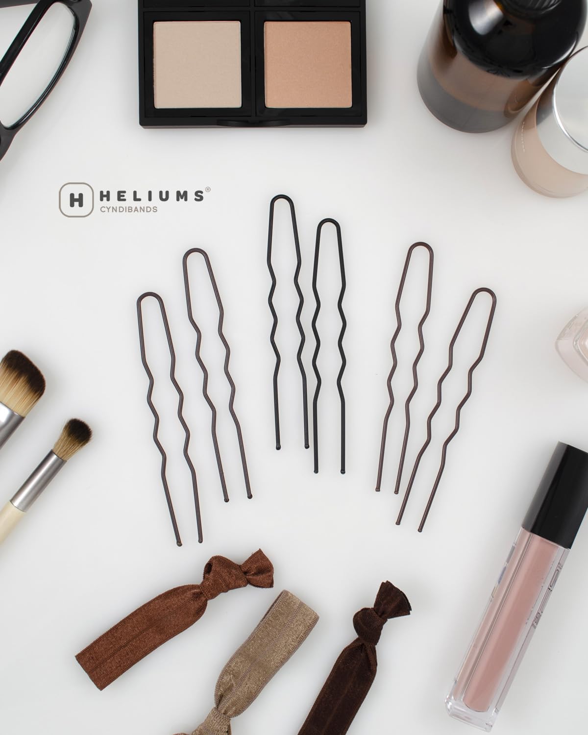 Heliums pins beside hair tools lifestyle shot showing professional-ready performance