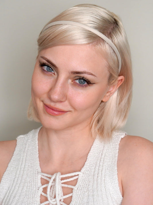 Heliums close-up of matte beige fabric texture showing quality wrap and gentle grip benefit reduced hair pulling
