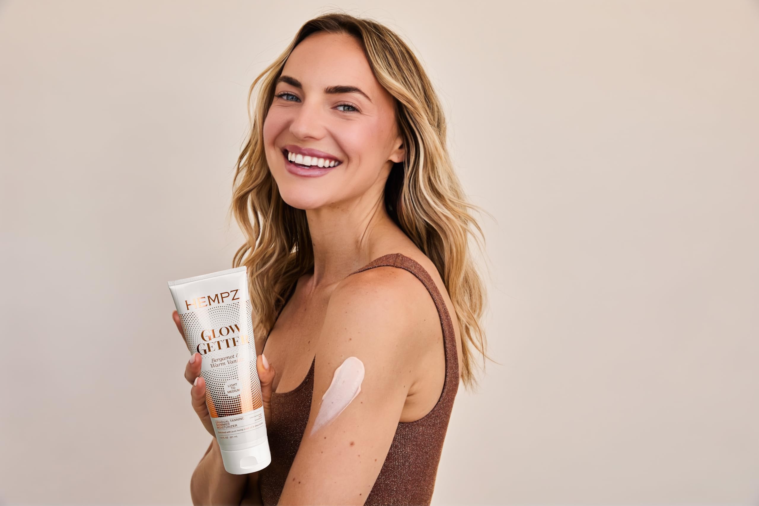 Hempz in-hand application on arm demonstrating buildable color and hydration