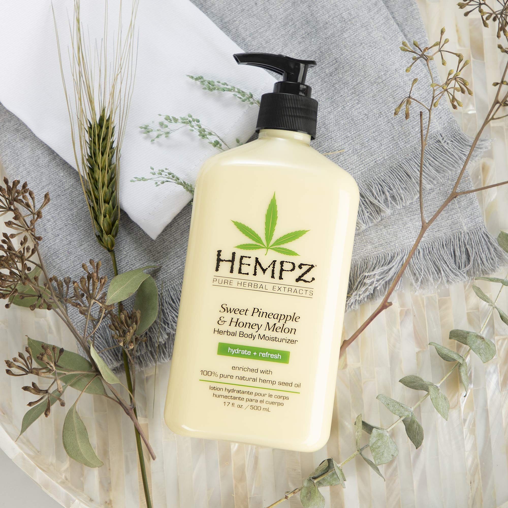 Hempz size comparison next to hand to illustrate 17 oz scale and long-lasting supply