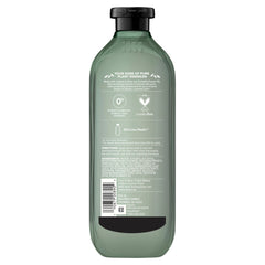 Herbal Essences bottle on bathroom shelf styled with plants for natural feel