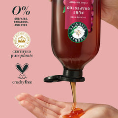Hand holding Herbal Essences shampoo while applying for easy lather