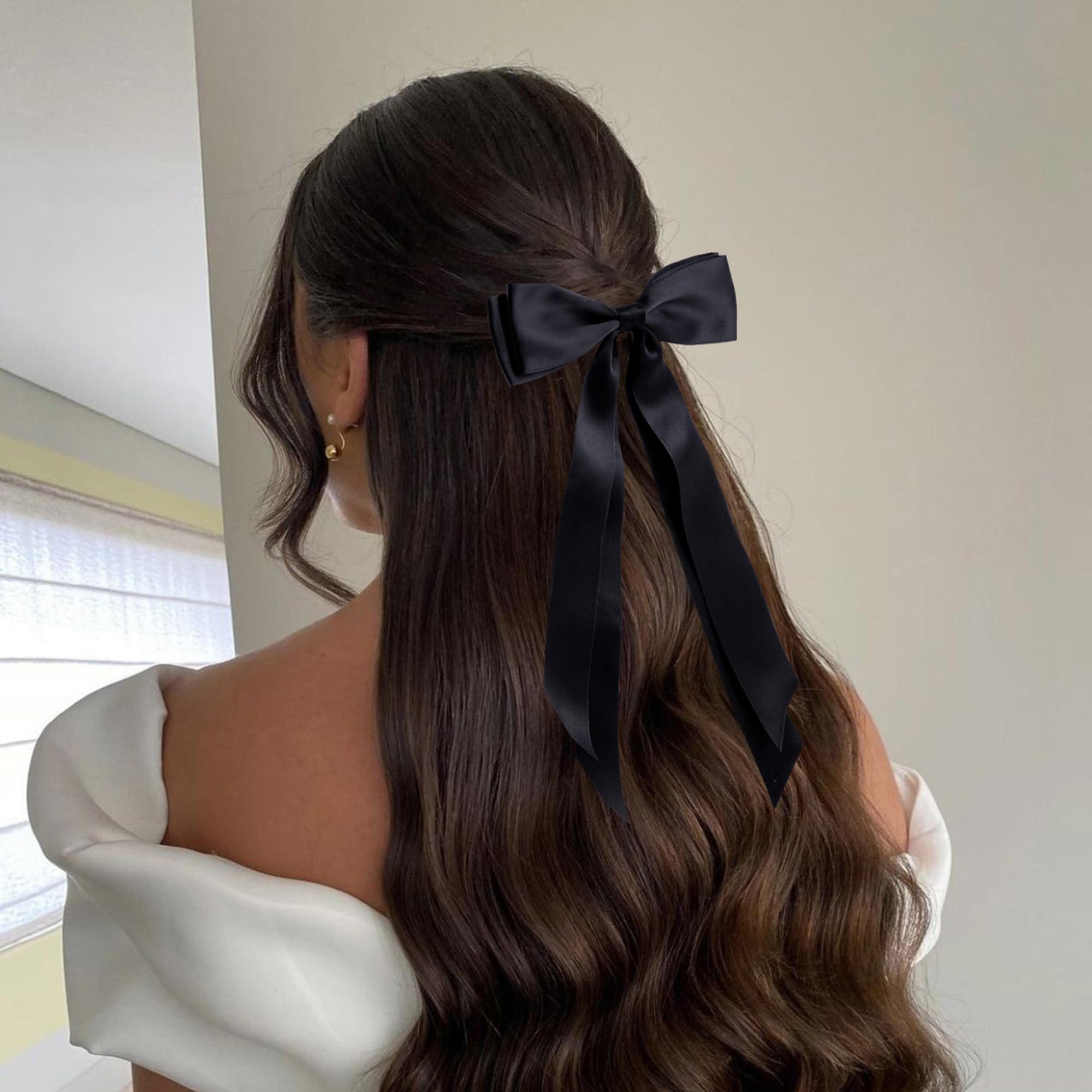 hisial bow worn in a ponytail, adds polished finishing touch