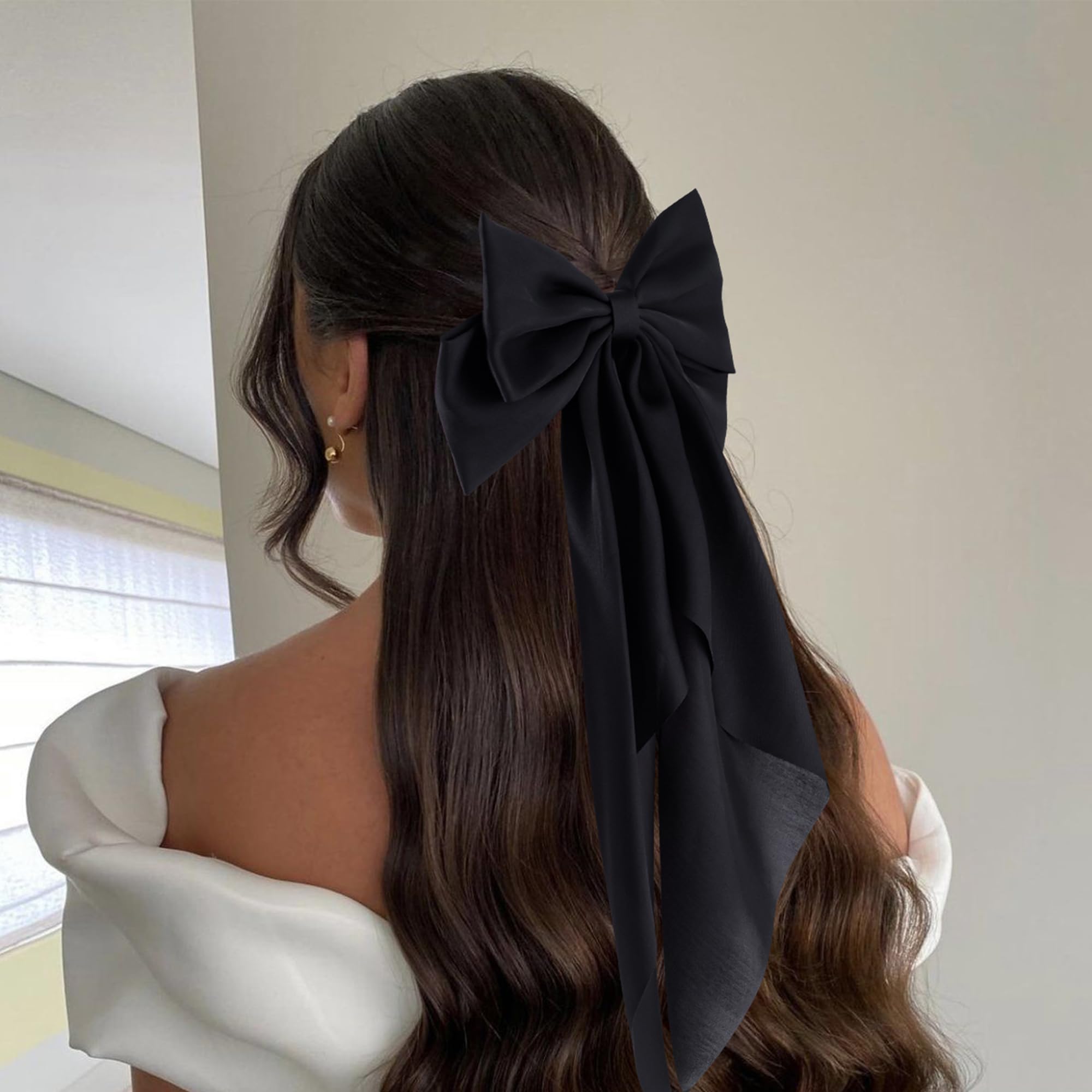 hisial bow clipped in ponytail demonstrating easy styling and volume