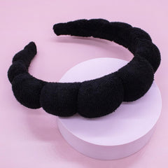 HitModa assortment of colored headbands styled on a vanity offering gift-ready options