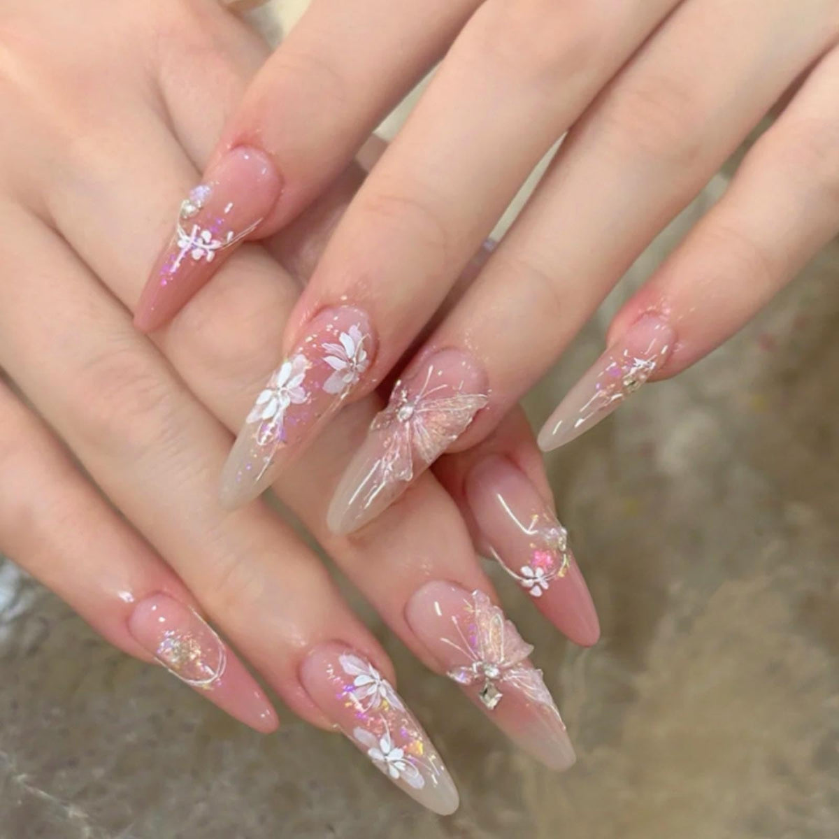Hkanlre front packaging showing 24-piece pink butterfly nails and included tools benefit quick setup