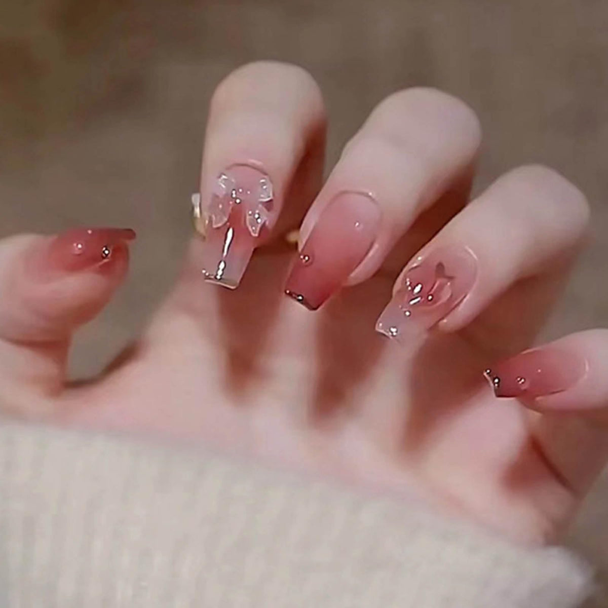 Hkanlre front packaging showing pink butterfly nails and kit contents benefit: clear product view