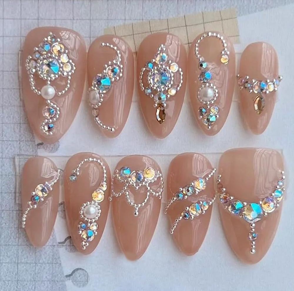 HNUIX manicure on hand featuring beads for a polished, professional look