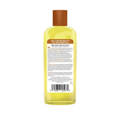 Hollywood Beauty oil being poured from bottle demonstrating lightweight texture