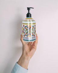 Home & Body Company Perugia Deruta next to a hand towel to show 21.5 fl oz bottle scale and long-lasting value