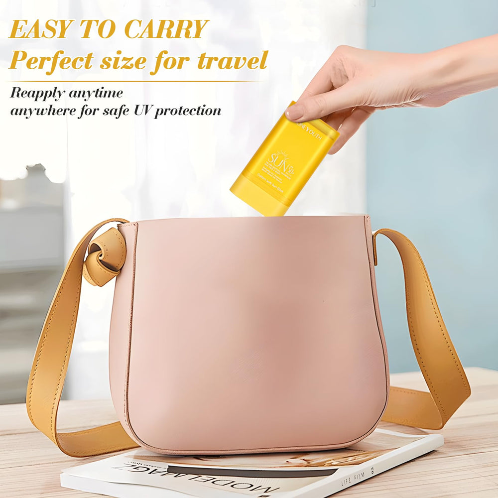 Honeyouth stick beside a hand to show 16g size and convenient portability