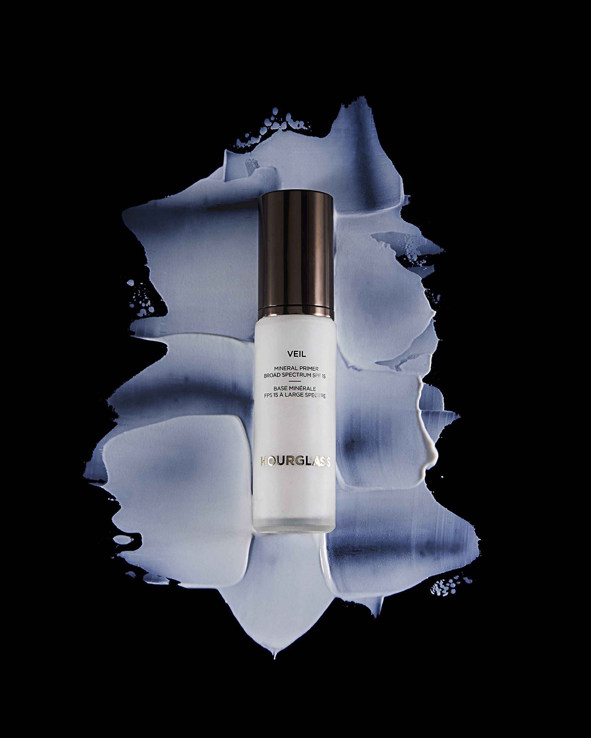 Hourglass Veil Mineral Primer in use on hand demonstrating smoothing effect and improved makeup adherence