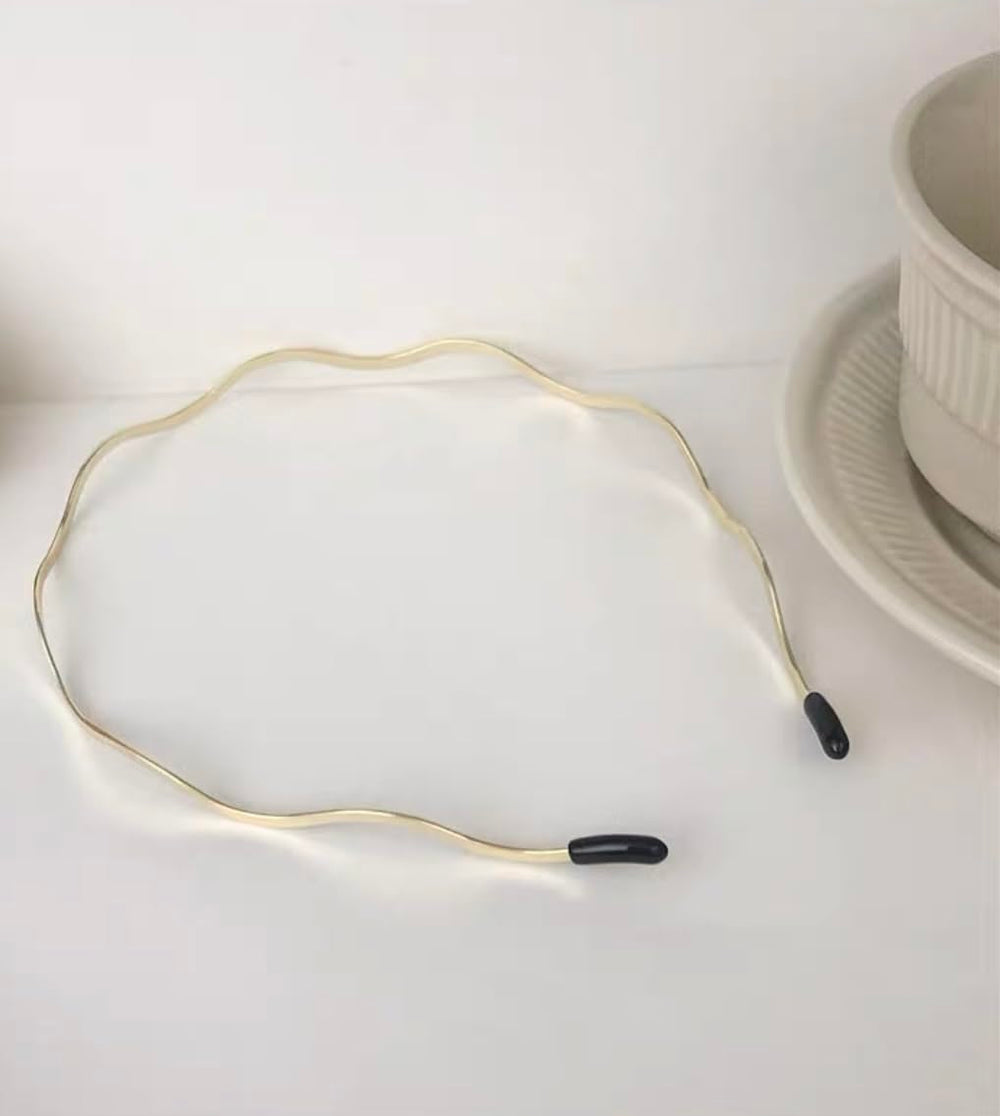 Huachi headband next to coin showing compact size and travel-friendly benefit