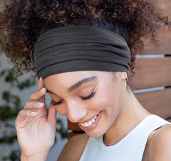 Huachi headband on hand for size comparison showing large coverage benefit