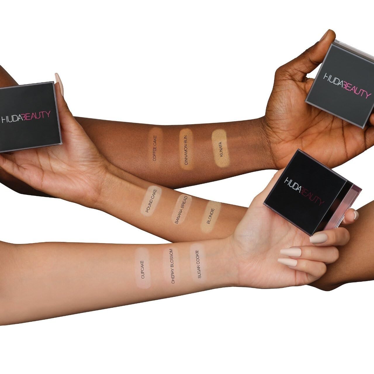 HUDA Beauty small scoop applying Cherry Blossom powder to target under-eye area