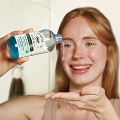 Humphreys bottle held in hand illustrating 8 fl oz size and portability