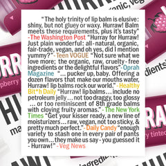 Hurraw! open cap applying balm to lips demonstrating easy application and color