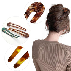 HYFEEL hair fork held in hand for scale showing 4.7-inch length and portability