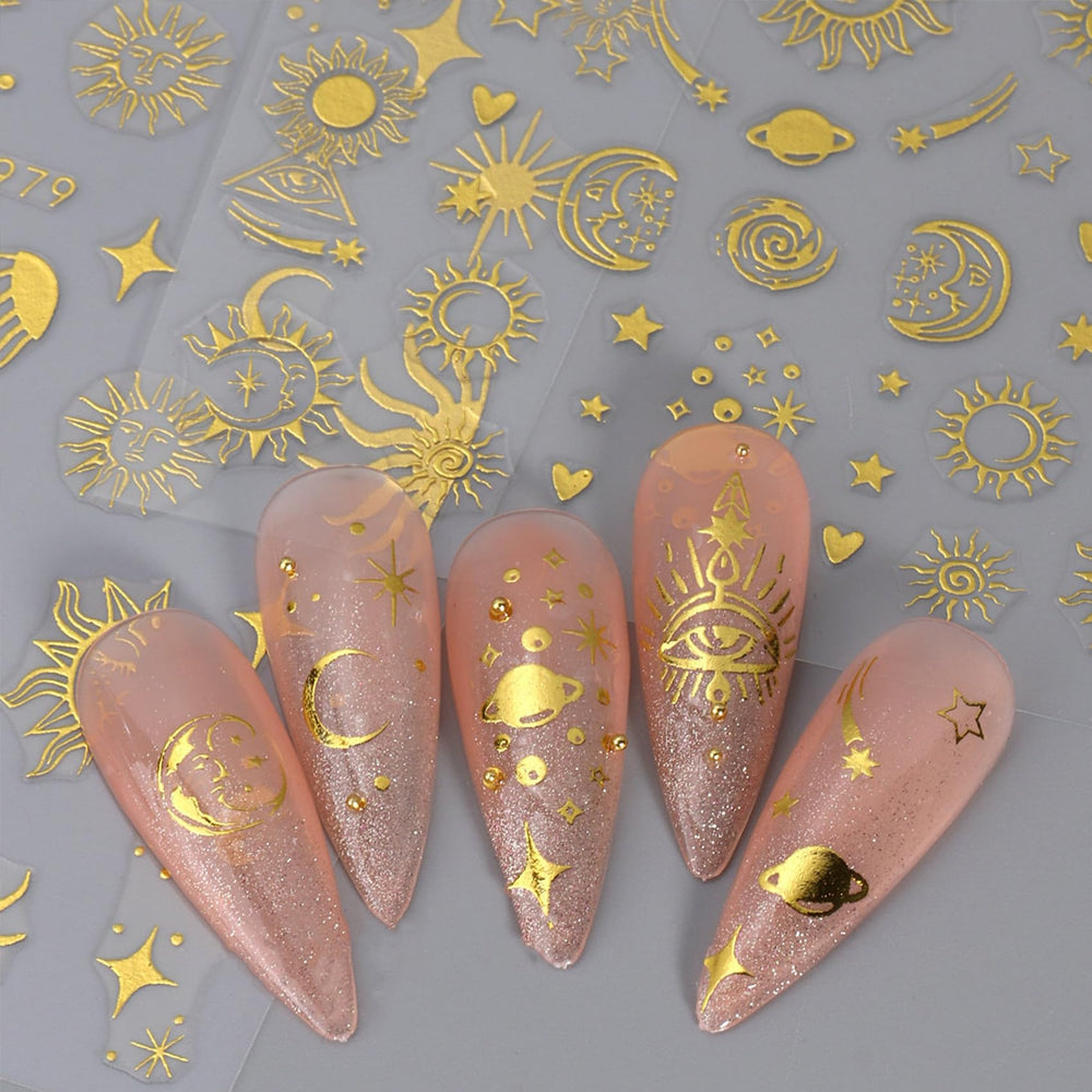 IDDFEVE finished manicure with gold suns and silver moons showing mixed-metal contrast benefit