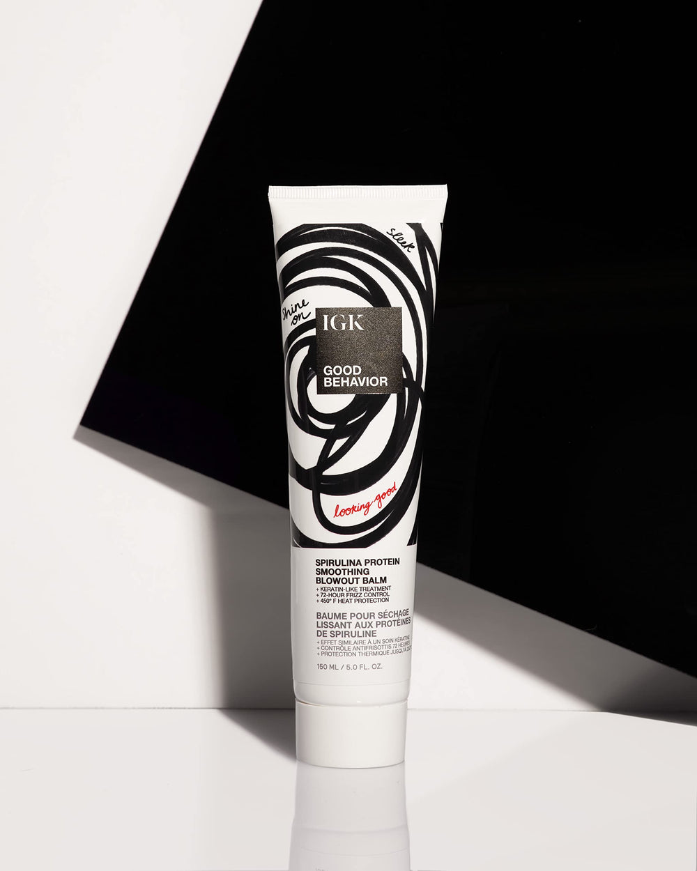 IGK product applied to damp hair mid-lengths, demonstrates frizz control benefit