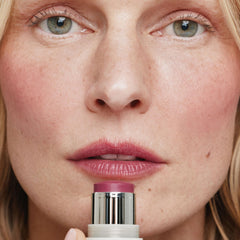 ILIA multi-stick applied to lips close-up for rich berry tint
