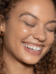 ILIA before-and-after half face illustrating visible smoothing and even tone