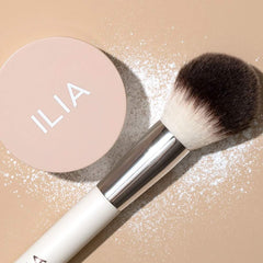 ILIA powder on fluffy brush demonstrating easy application and natural finish