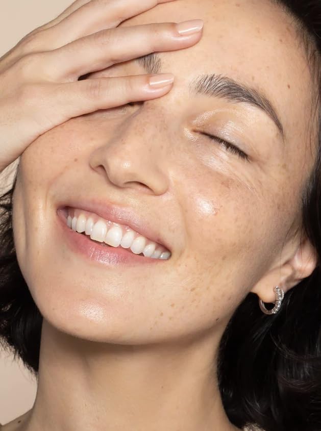 ILIA applying tint with fingertips showing quick, seamless skin blending