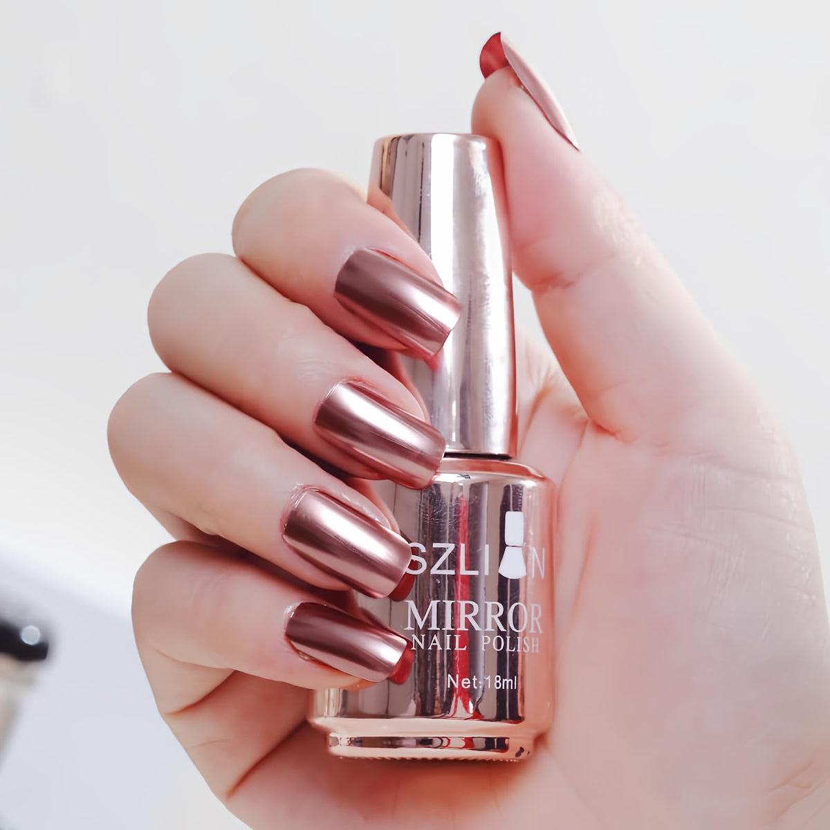 IMGDD bottle front showing rose gold chrome finish and brand appeal