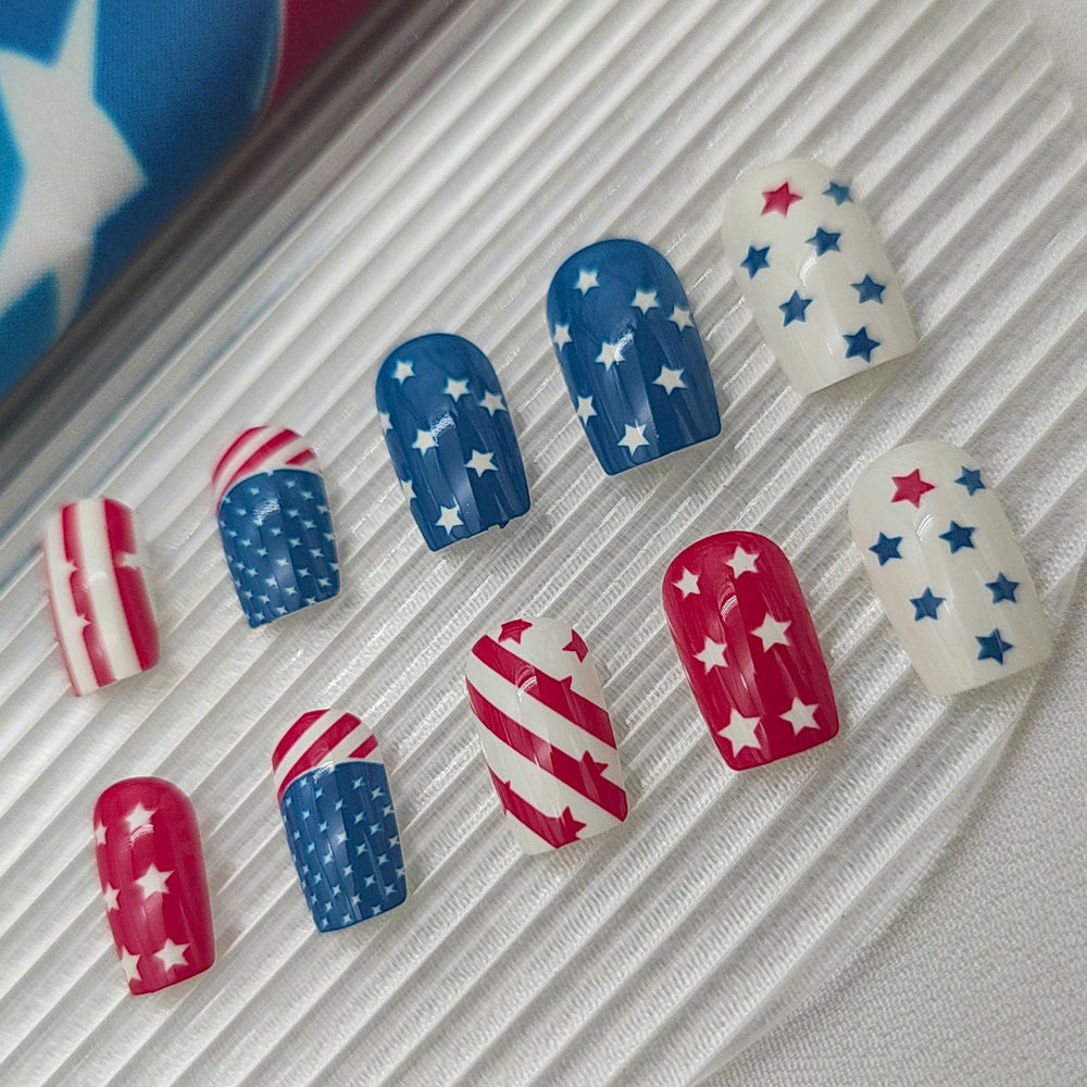 IMPOBLNS press-on nails worn on hand in festive setting demonstrating instant patriotic manicure