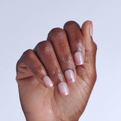 imPRESS close-up of a single Soft Petals nail showing pink French tip for natural look