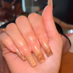 IMRAIN application in progress pressing on nail illustrating easy, secure adhesion