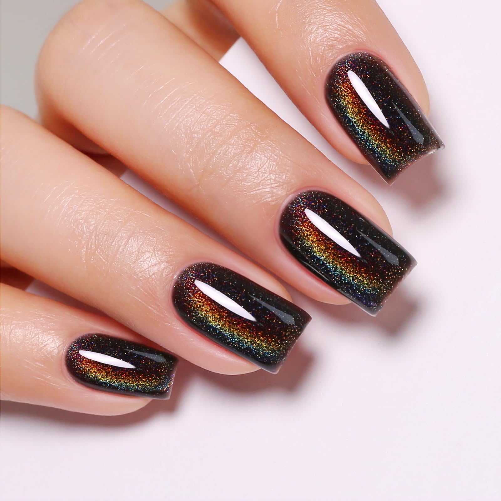Imtiti magnet held over wet nail showing cat-eye formation for dramatic effect