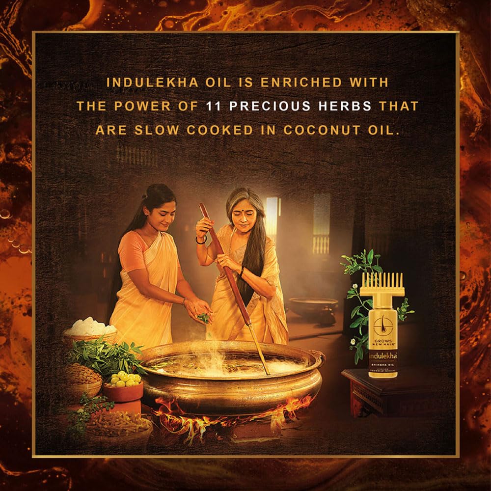 Indulekha Bringha bottle in hand for scale showing travel-friendly convenience