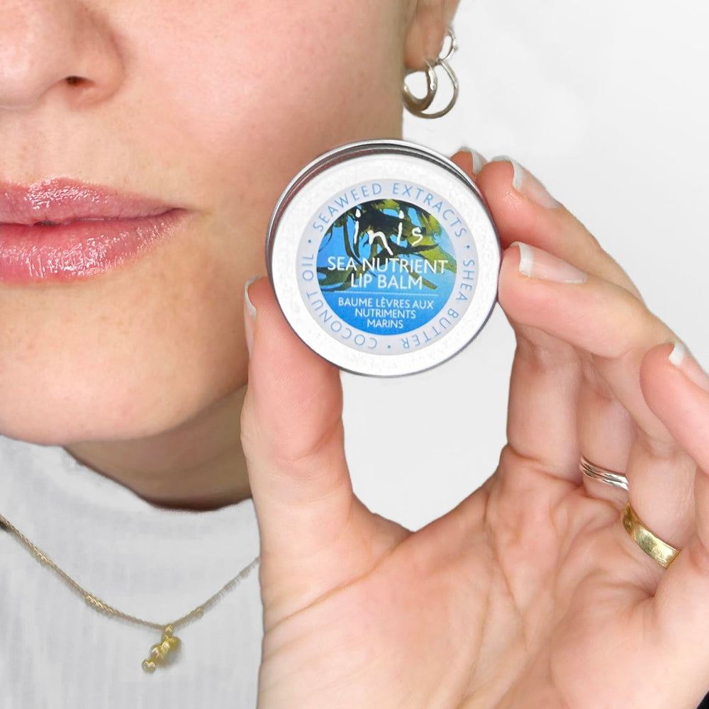 Inis Sea Nutrient Lip Balm lifestyle at beach showing portable tin and refreshing benefit