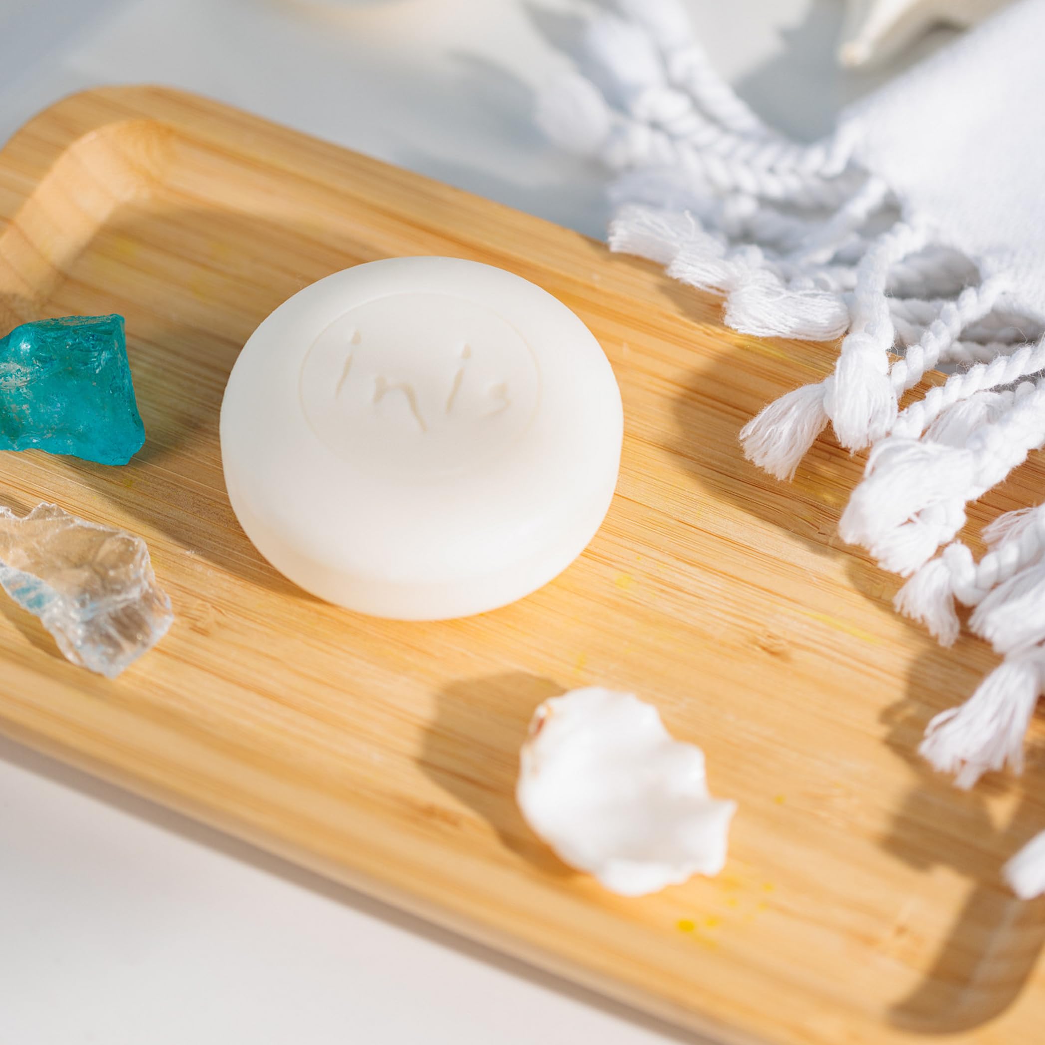 Unwrapped Inis soap edge revealing compact bar built for long-lasting use benefit
