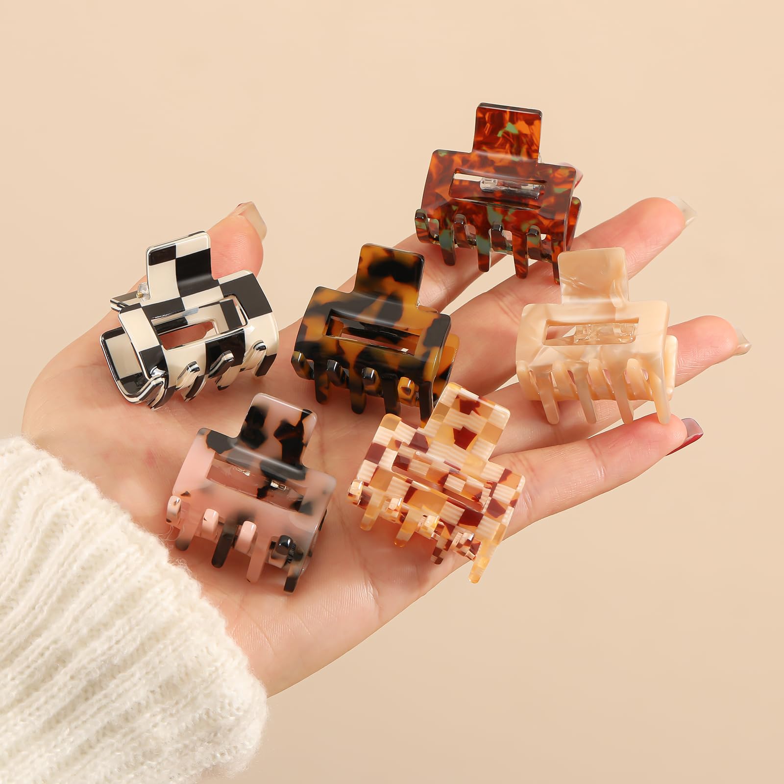 Interesse hand holding a clip to show compact 1.3-inch size for travel