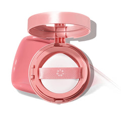 INTO YOU compact front view showing Sunlit Peach shade and portable design benefit
