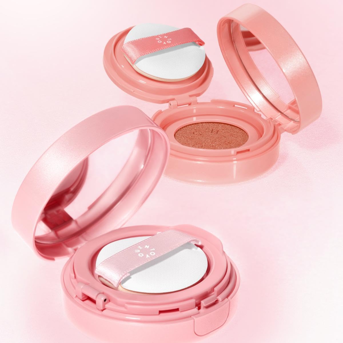 INTO YOU compact in hand showing size and travel-ready convenience benefit