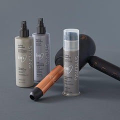 ion Silk Drops on bathroom vanity next to styling tools for polished routine
