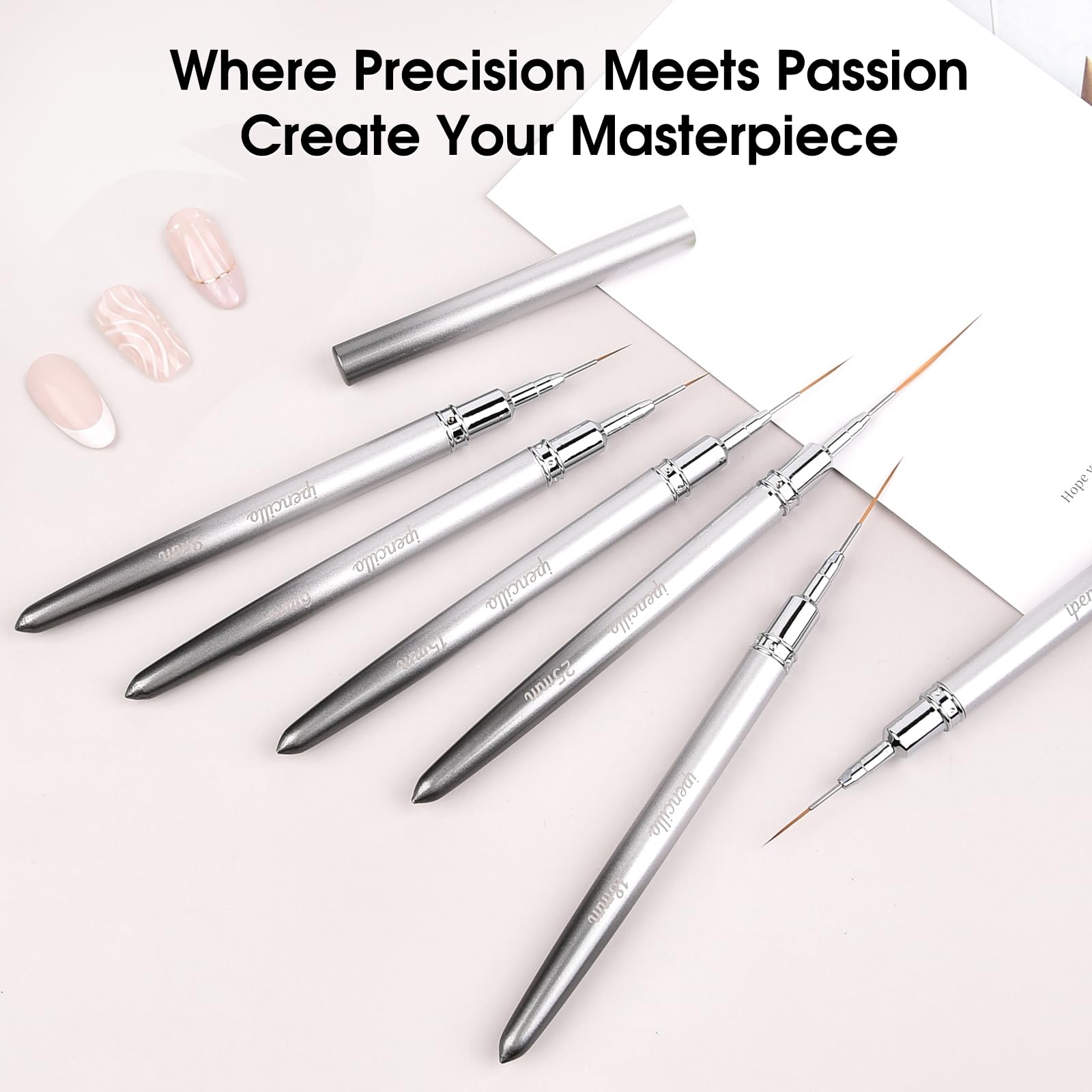 IPENCILLO brushes held between fingers to show scale and comfortable grip for detailed work