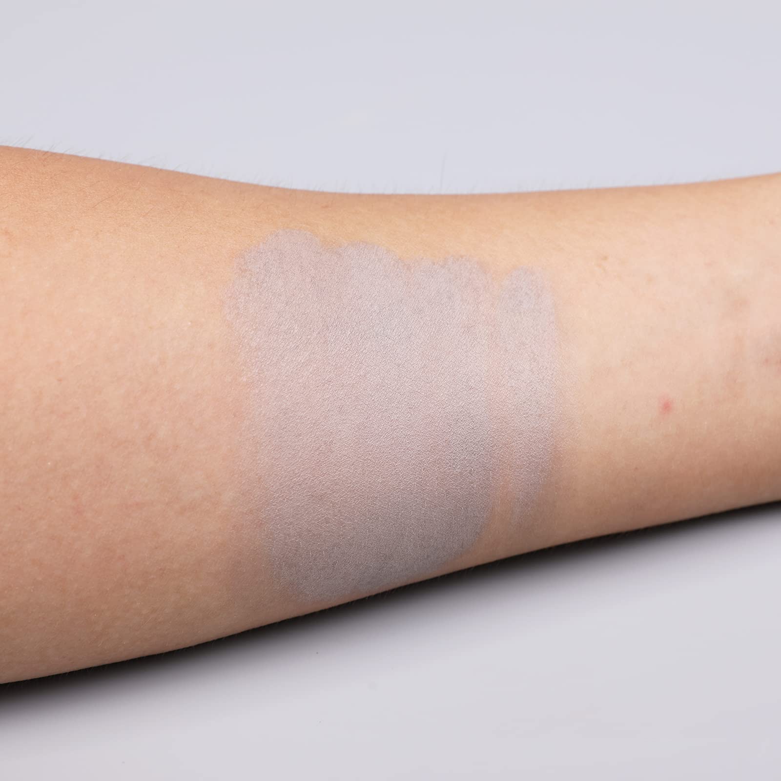 IS'MINE shade swatches on arm displaying true grey payoff and layering options