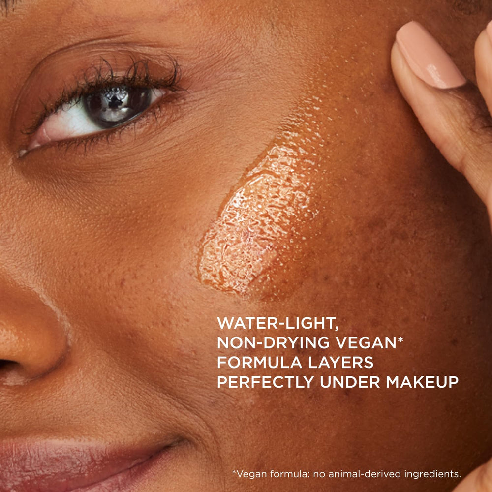 IT Cosmetics 1 fl oz bottle in hand for clear size comparison and travel-friendly benefit