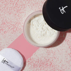 IT Cosmetics powder next to a coin for size and travel-friendly scale comparison